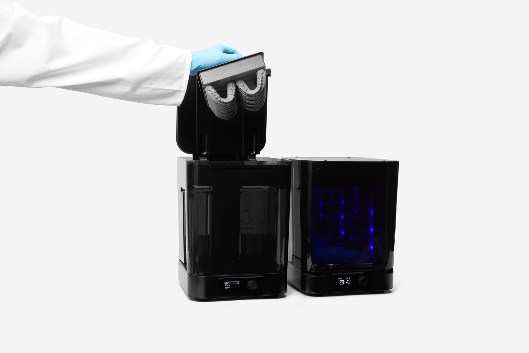 Image shows dental technician removing digital dentures from Form Wash, a post-processing station from Formlabs