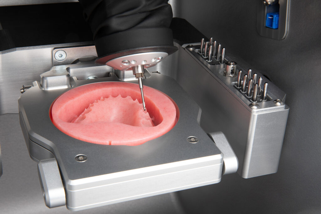 Image shows a close up of a dentures being milled on vhf K5+ dental mill