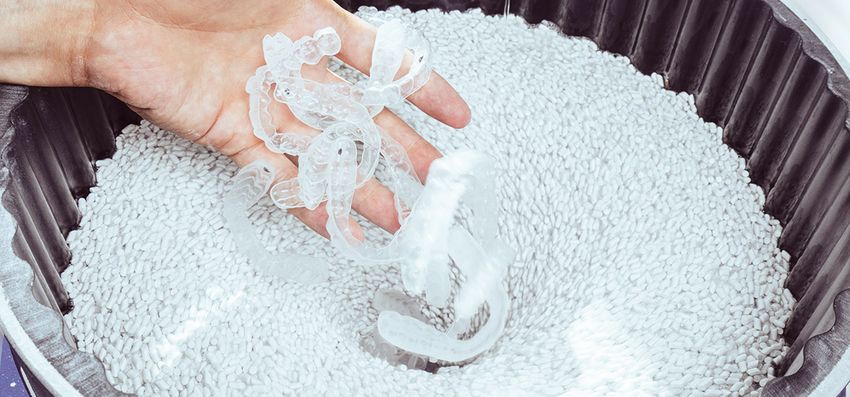 Image of bite splints taken out from a finishing media bucket